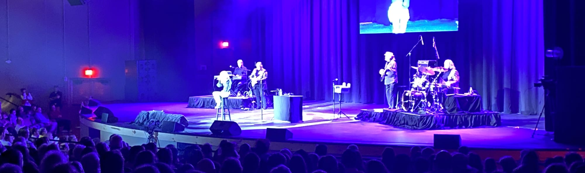 signer on stage in chair washed out by the lights El Paso